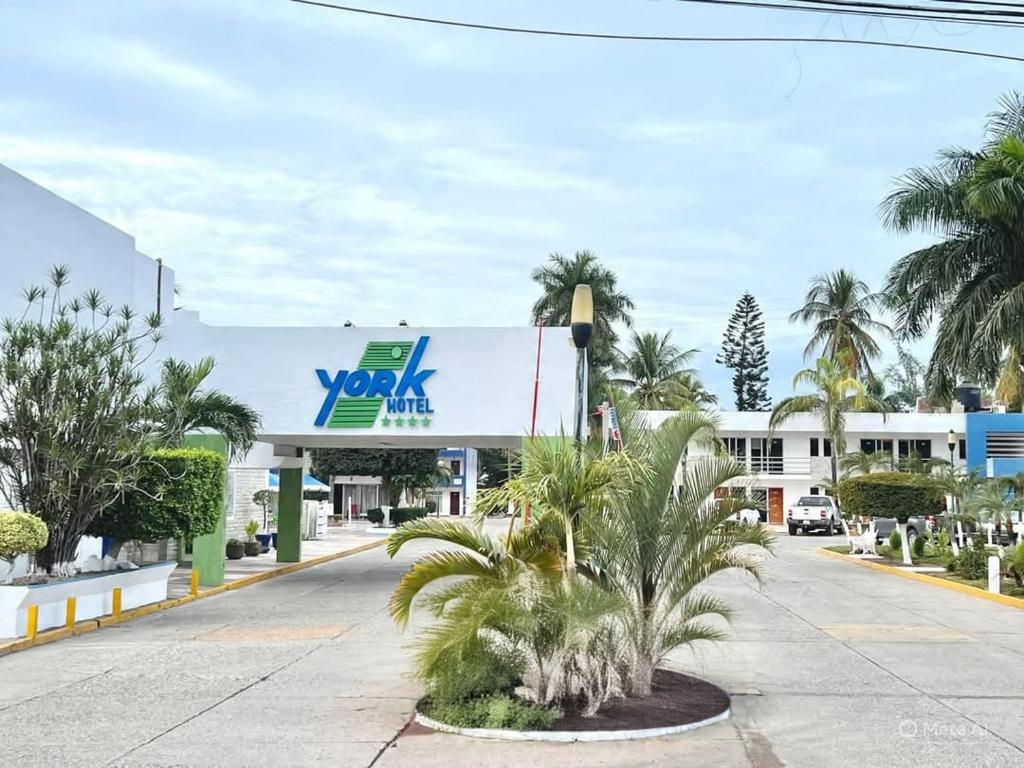 a view of a yokota gas station with palm trees at Hotel York in Guamúchil