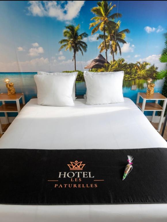 a bed with a hotel its rentals sign on it at Hôtel les Paturelles in Avesnelles