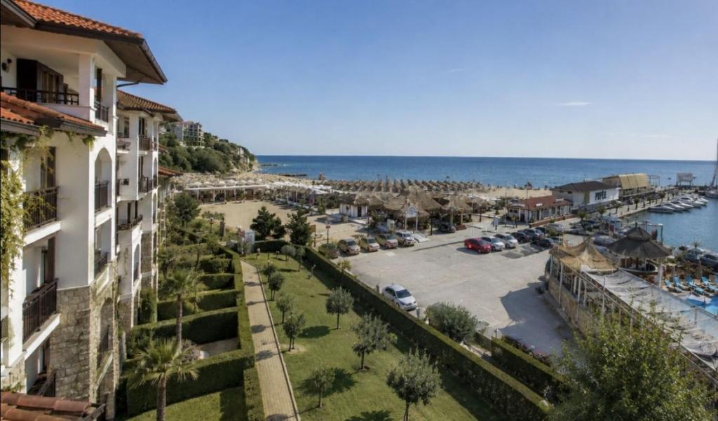 a view of a marina from a building at Beachfront Apartment with Garden at Venid Sandy Beach - Apartment Marina Dinevi View in Sveti Vlas