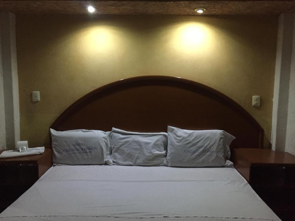 Postel nebo postele na pokoji v ubytování Hotel Paraiso Express