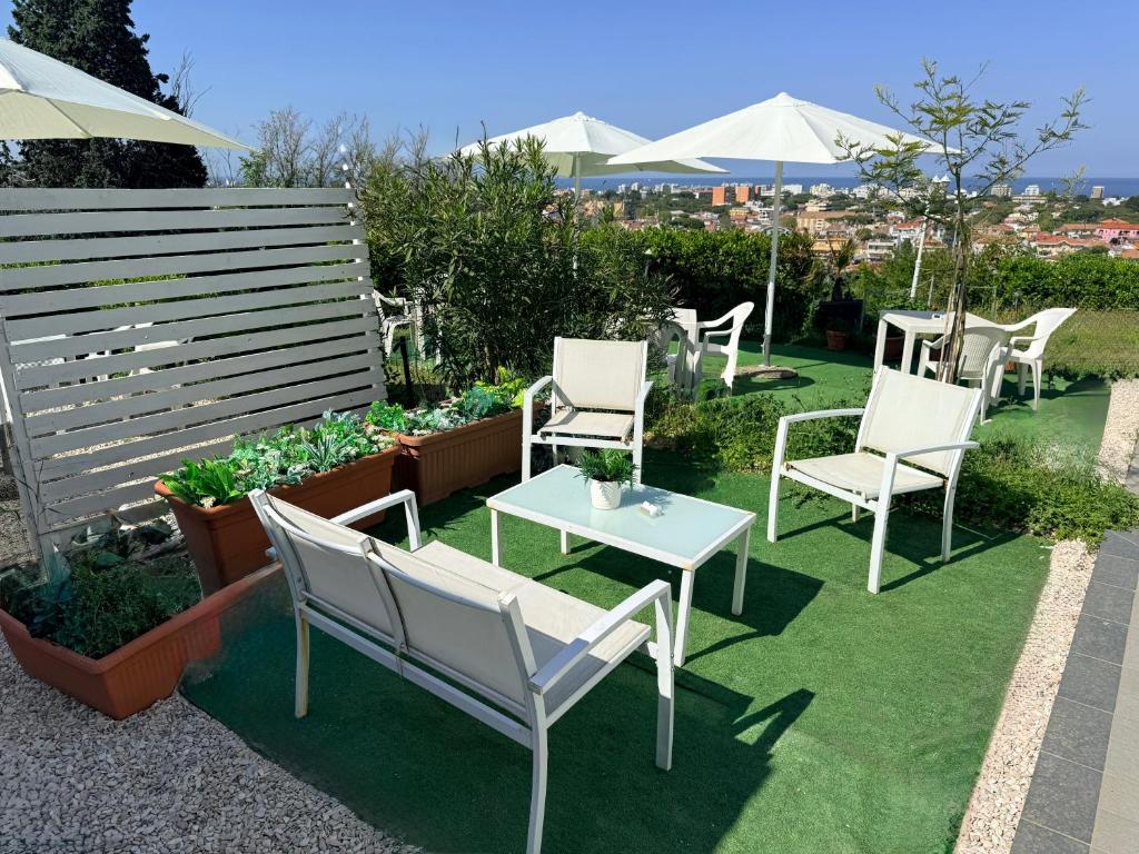 a group of chairs and a table in a garden at B&B Cá Bianca Ventisette Riccione in Riccione