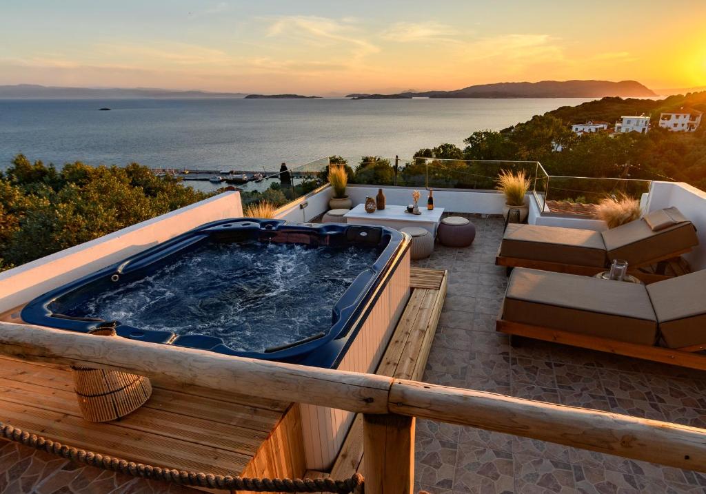 a hot tub on a deck with a view of the ocean at LemonTree Villa Rooftop Jacuzzi And Sea Views in Skopelos Town