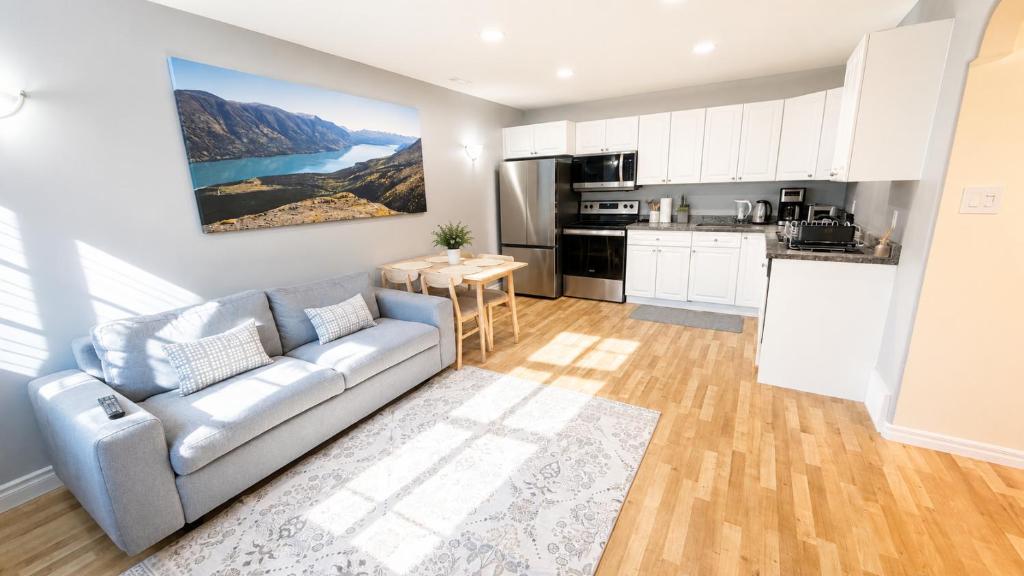 a living room with a couch and a kitchen at Bright & Cozy Private 1BR Suite in Whitehorse