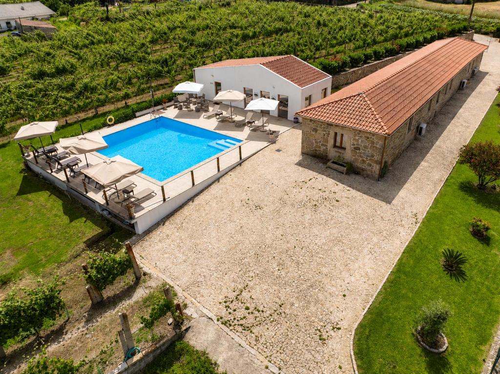 an aerial view of a house with a swimming pool at Quinta de Real in Valença