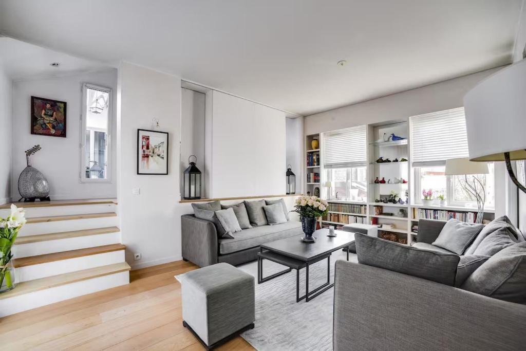 a living room with a couch and a table at 100 m terrace parking view of the Eiffel Tower in Saint-Cloud