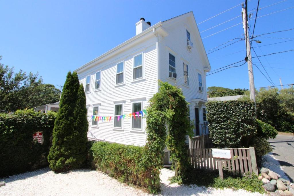 a white house with bushes in front of it at High Tide Upper Level in Provincetown