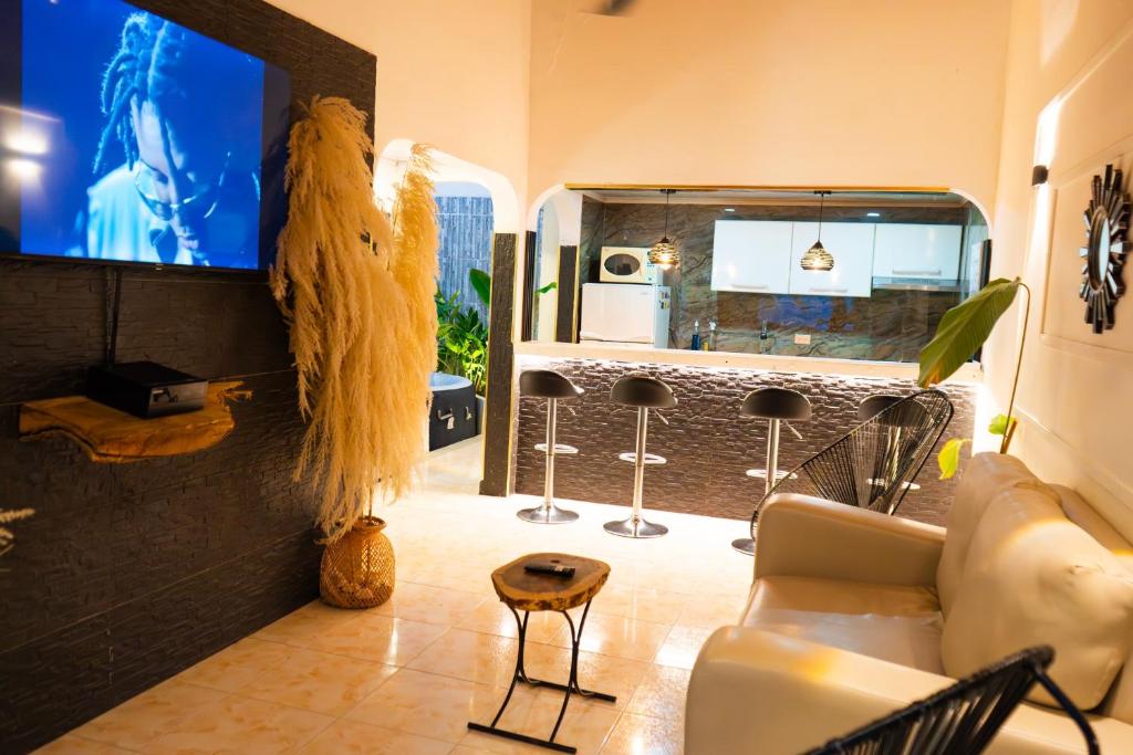 a living room with a couch and a bar at Le”More House in Girardot