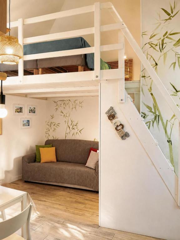 a living room with a loft bed and a couch at Sanremo Apartments - Marilux in Sanremo