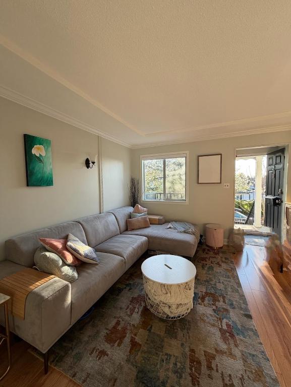 a living room with a couch and a coffee table at Bright & Spacious Full Family Home in Vancouver