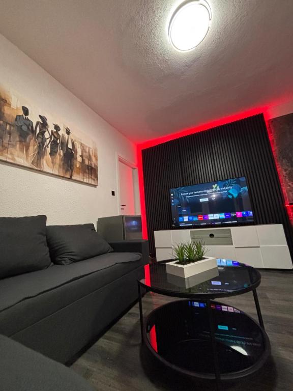 a living room with a couch and a tv at Kuća za odmor Štiba in Vinkovci