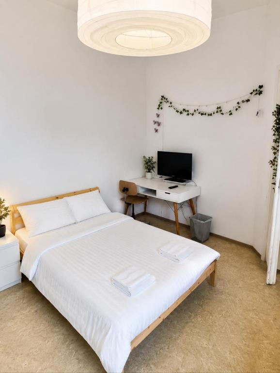 a bedroom with a bed and a desk with a computer at StaySpace in Graz