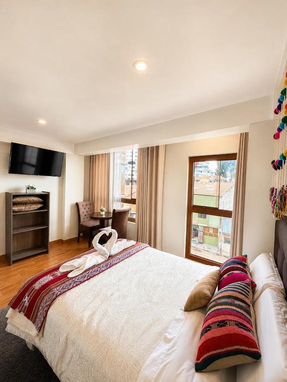a bedroom with a large bed with a towel on it at Hospedaje chakana inn in Cusco