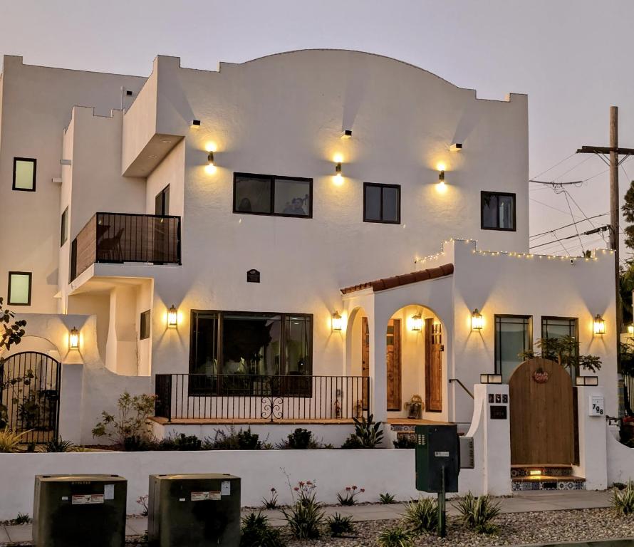 a large white building with lights on it at Rise Suites Oceanside in Oceanside