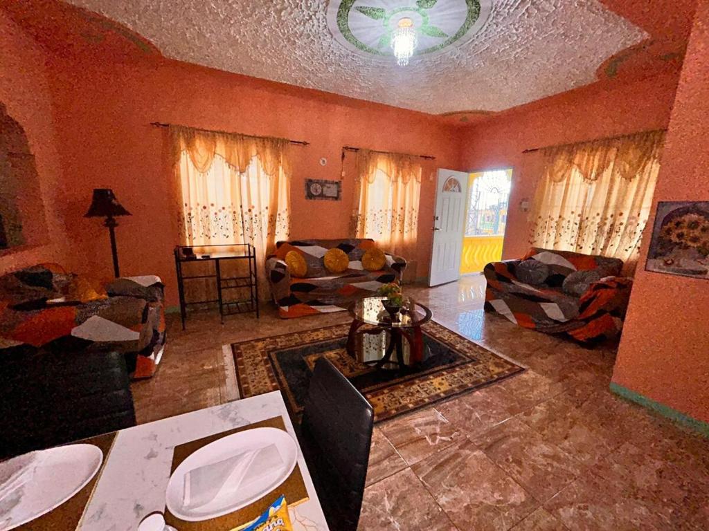 a large living room with red walls and furniture at Mammee Bay Hideaway in Ocho Rios