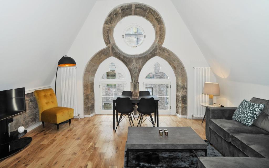 a living room with a couch and a table at Linton Collection - Blackfriars Lofts in Edinburgh