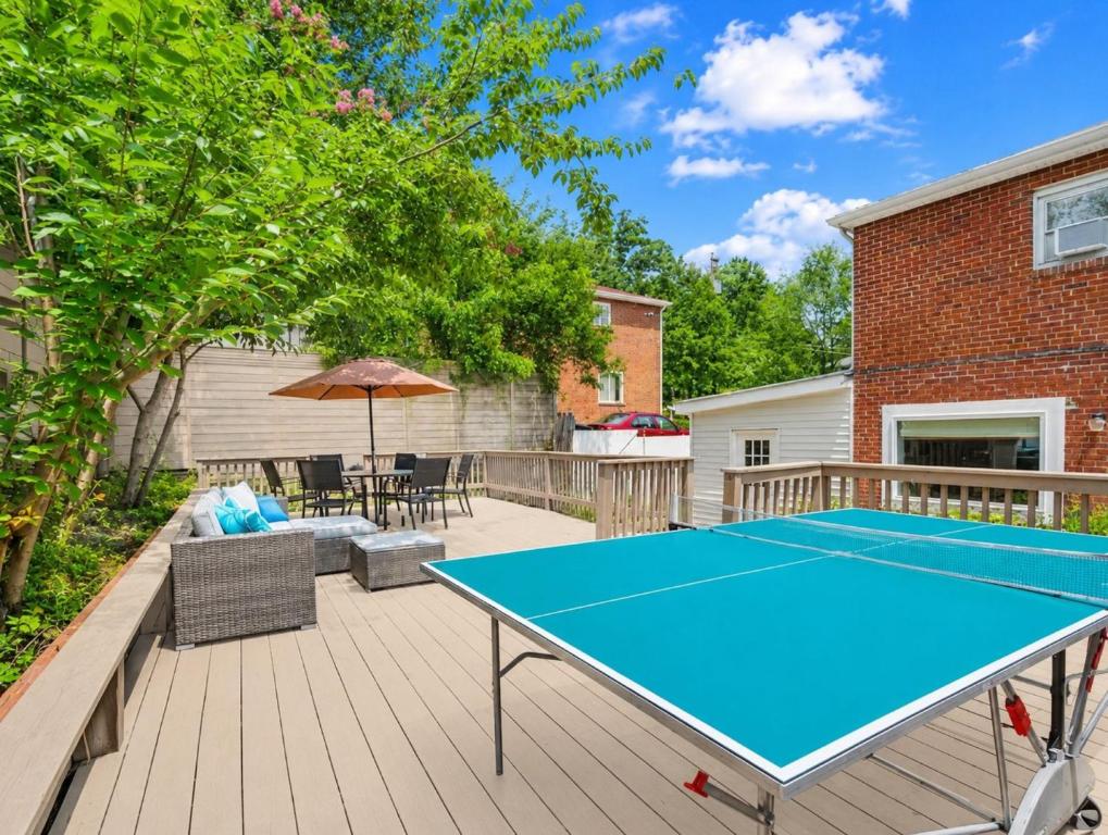 a ping pong table on a deck with a tennis court at Contemporary Lux Pad Patio in Alexandria