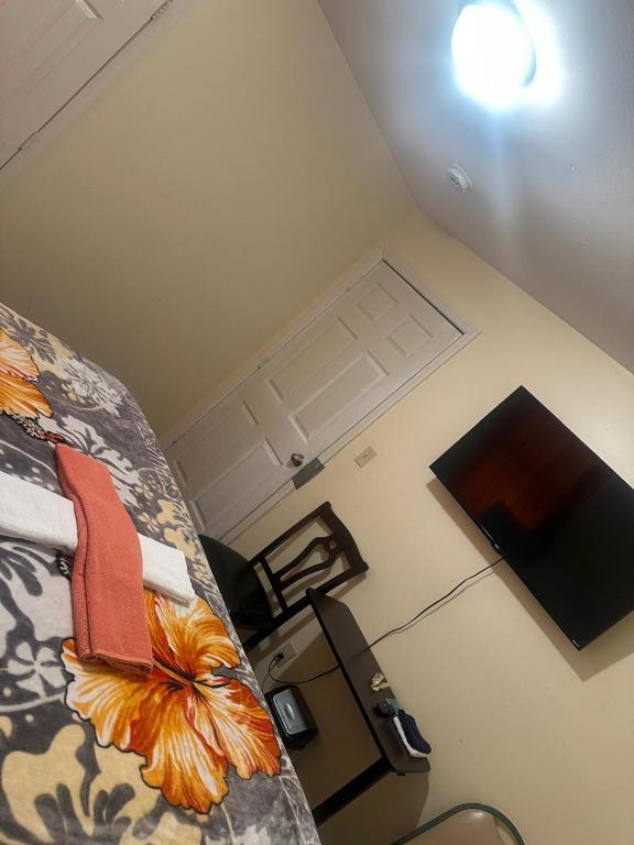 an overhead view of a bedroom with a bed and a television at Divine Villa 67 Sherman Ave in Newark