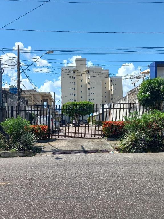 a black metal fence with buildings in the background at Elizondo Pousada Eneias Pinheiro in Belém
