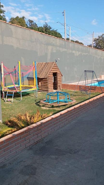 a park with a playground with slides and swings at Chácara do tio Tuta in Araçariguama