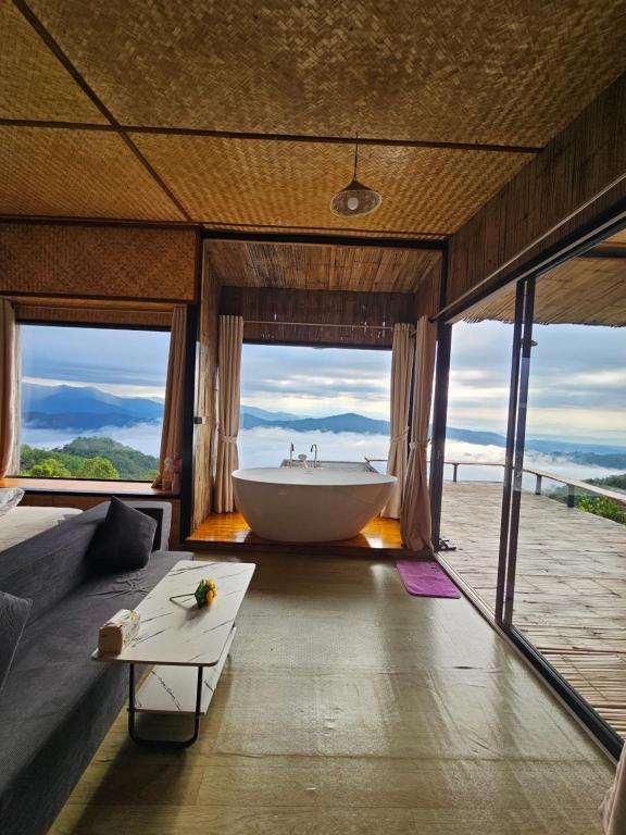 a large bathroom with a tub and a large window at Mon Ngo misty haven B2 in Ban Mae Ta Man