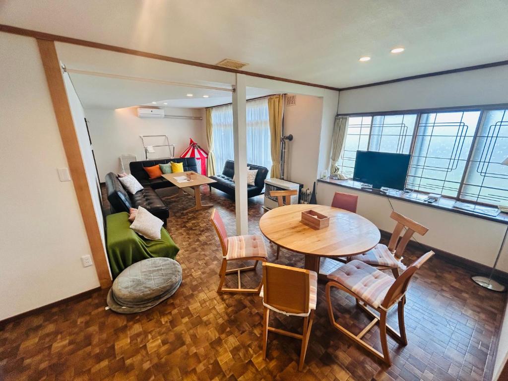 a living room with a table and a couch at Higashikawa home in Higashikawa