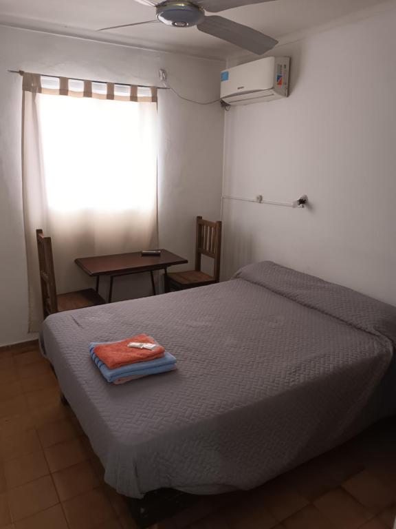 a bedroom with a bed with a towel on it at Hospedaje Alicia in Barraquero