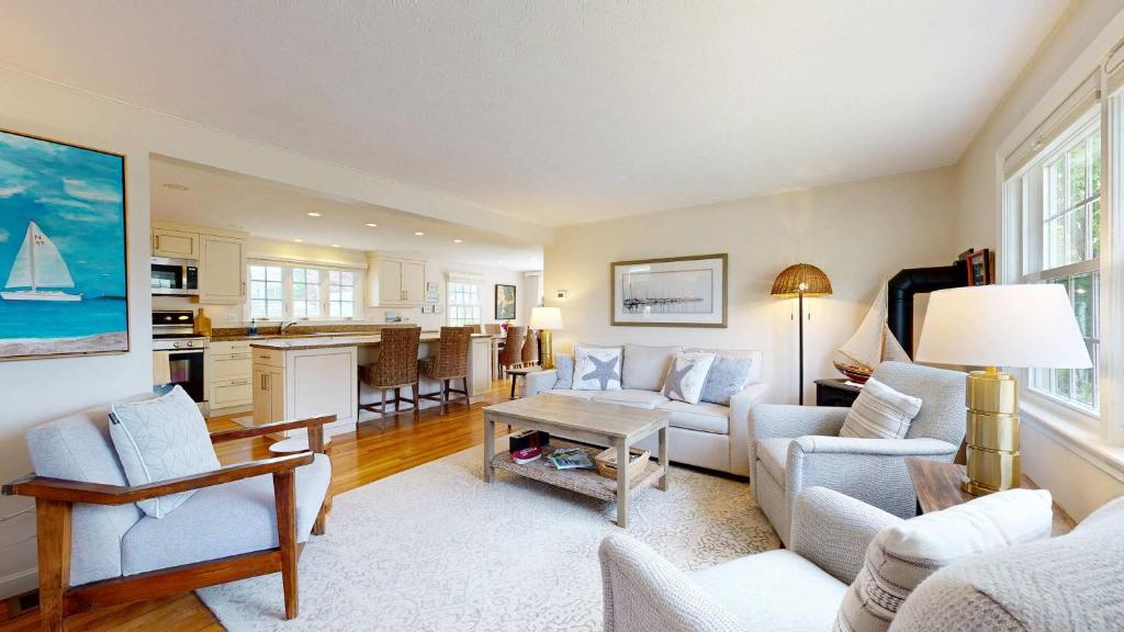 a living room with a couch and a table at Harborside Retreat in Falmouth