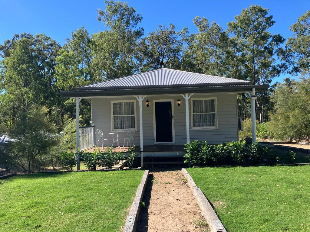 a small house with a green lawn in front of it at Casa Tranquilo in Kanighan