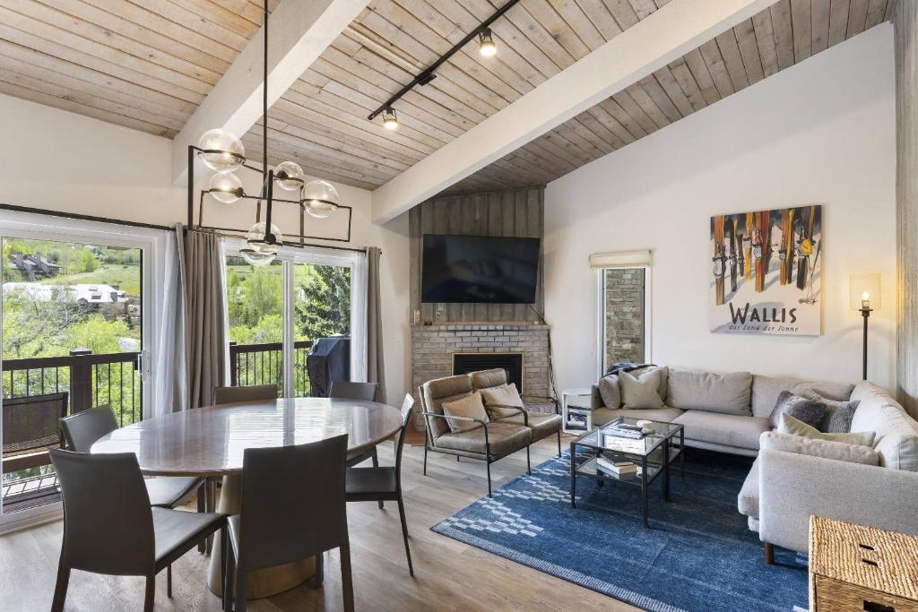 a living room with a table and a couch at Woodbridge 29E in Snowmass Village