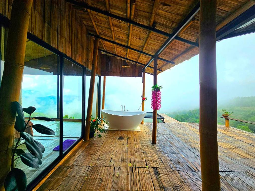 a bathroom with a bath tub on a wooden deck at Mon Ngo misty haven B3 in Ban Nong Chaeng