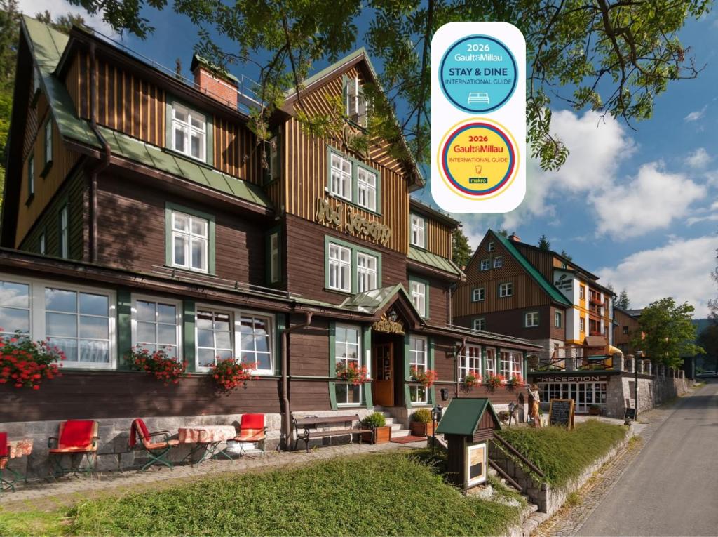 a large house with a sign in front of it at Hotel Pod Jasany in Špindlerův Mlýn