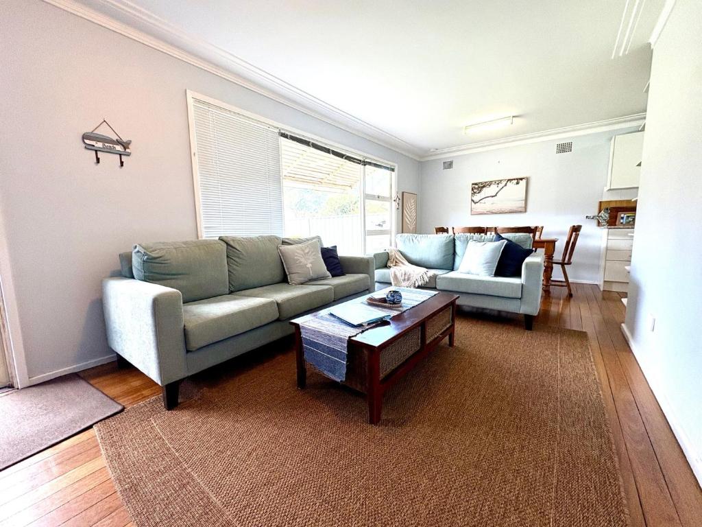 a living room with a couch and a coffee table at Horace Street 8 in Shoal Bay