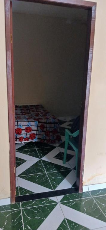 a room with a tile floor with a chair in it at Lazer do DUELÃO in Pão de Açúcar