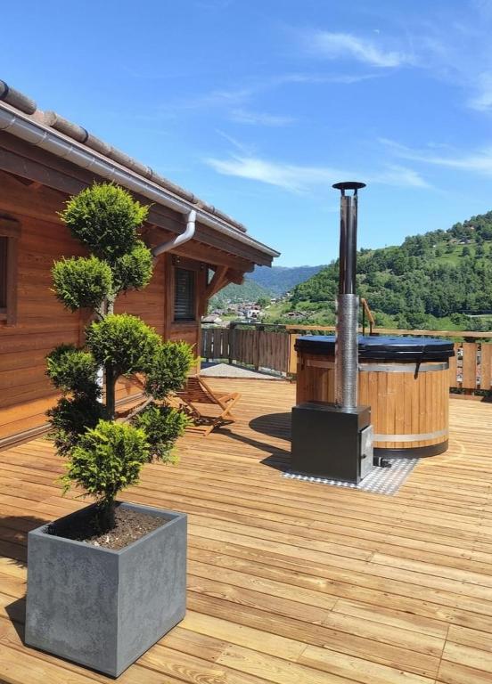a deck with a hot tub on a house at Le Bois Lumen 1 in La Bresse