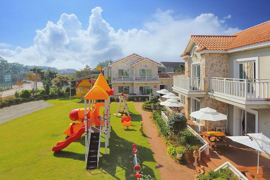 a backyard with a playground with a slide at Taean Modern186 Pension in Taean