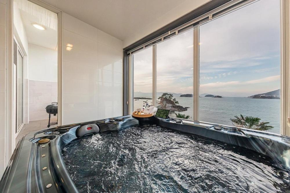 an indoor water slide in a room with a large window at M129 Pension Namhae in Namhae