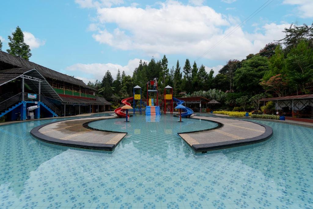 a pool of water with a playground in it at Barusen Hills By BHATARA in Gambung