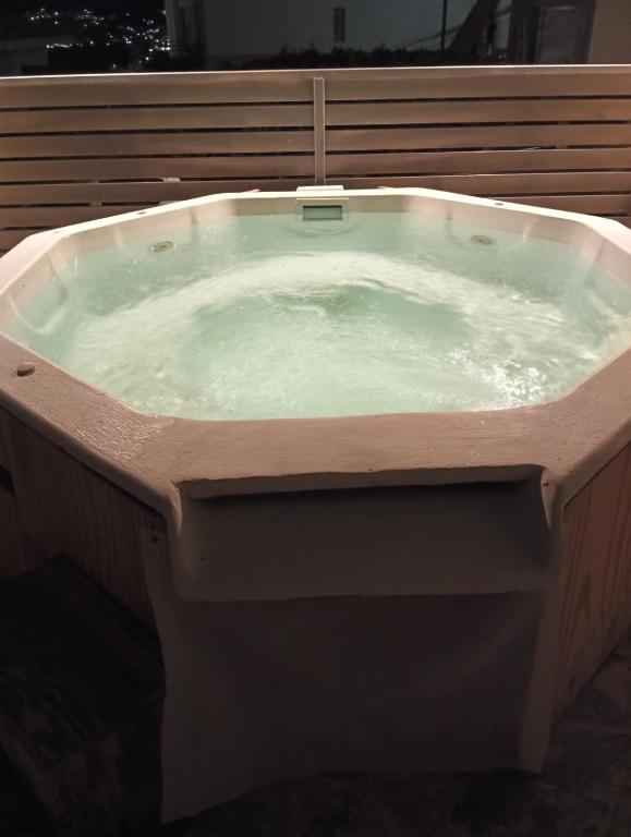 a large bath tub with water in it at Parishouse by zarkco in Porto Rafti