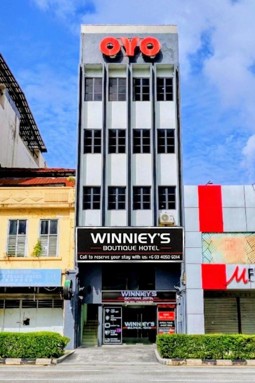 a building with a sign on the side of it at Winnieys Boutique Hotel in Kuala Lumpur