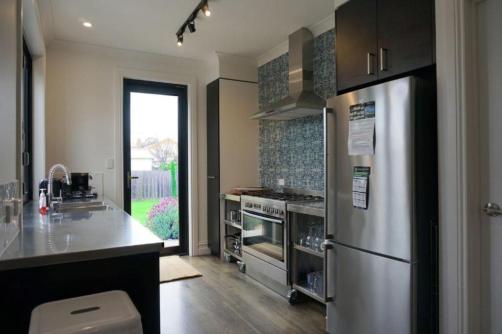 a kitchen with a stainless steel refrigerator and a counter at Chevignon in Queenscliff