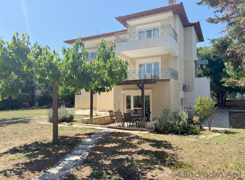 a villa with a view of the house at Schinias Forest Beach House in Marathon