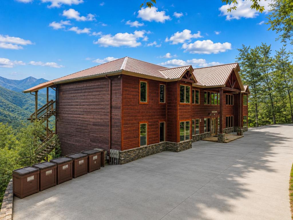 a large wooden house with a large driveway at Sycamore Mansion in Pittman Center