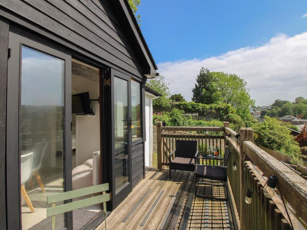 a deck with a sliding glass door and a couch at West Island in Kingsbridge