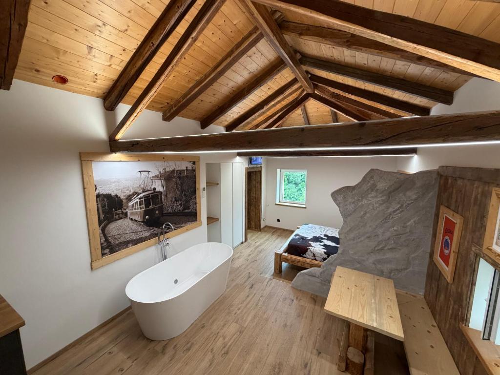 a room with a bath tub and a bed in it at Chalet Al bosco incantato in Trieste