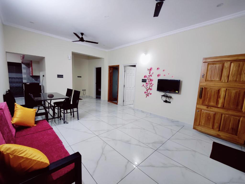 a living room with a couch and a table at Mysore Studio Rooms in Mysore