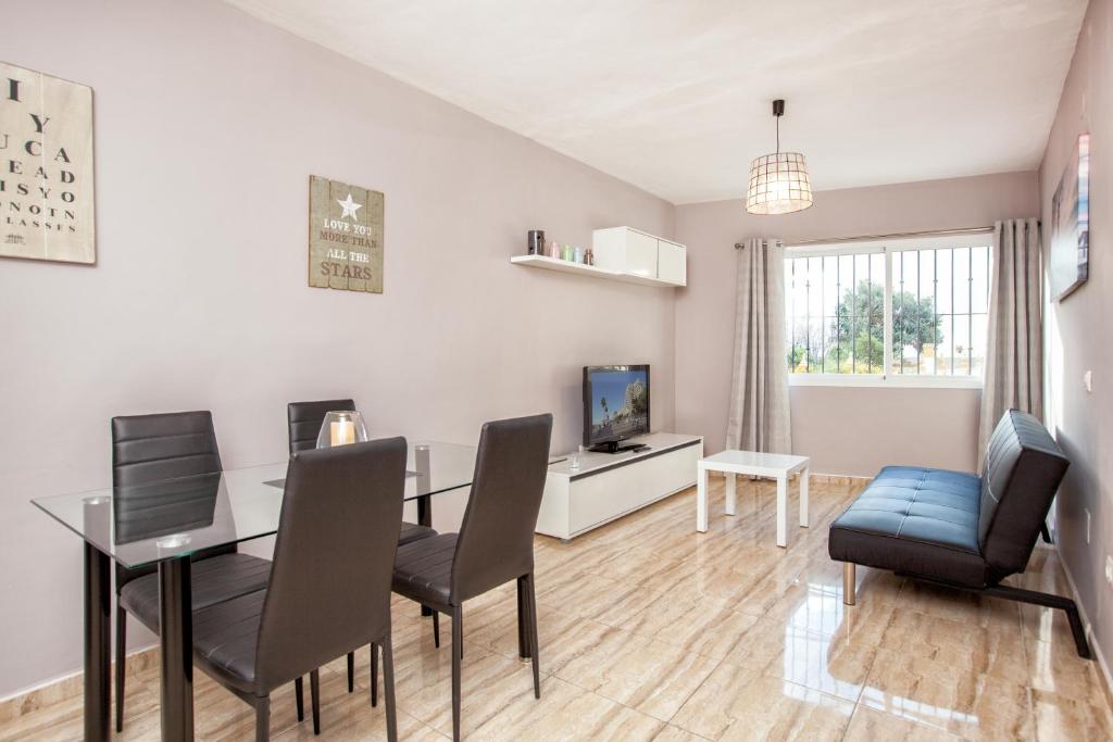 a living room with a dining room table and chairs at Doña Elena in Fuengirola