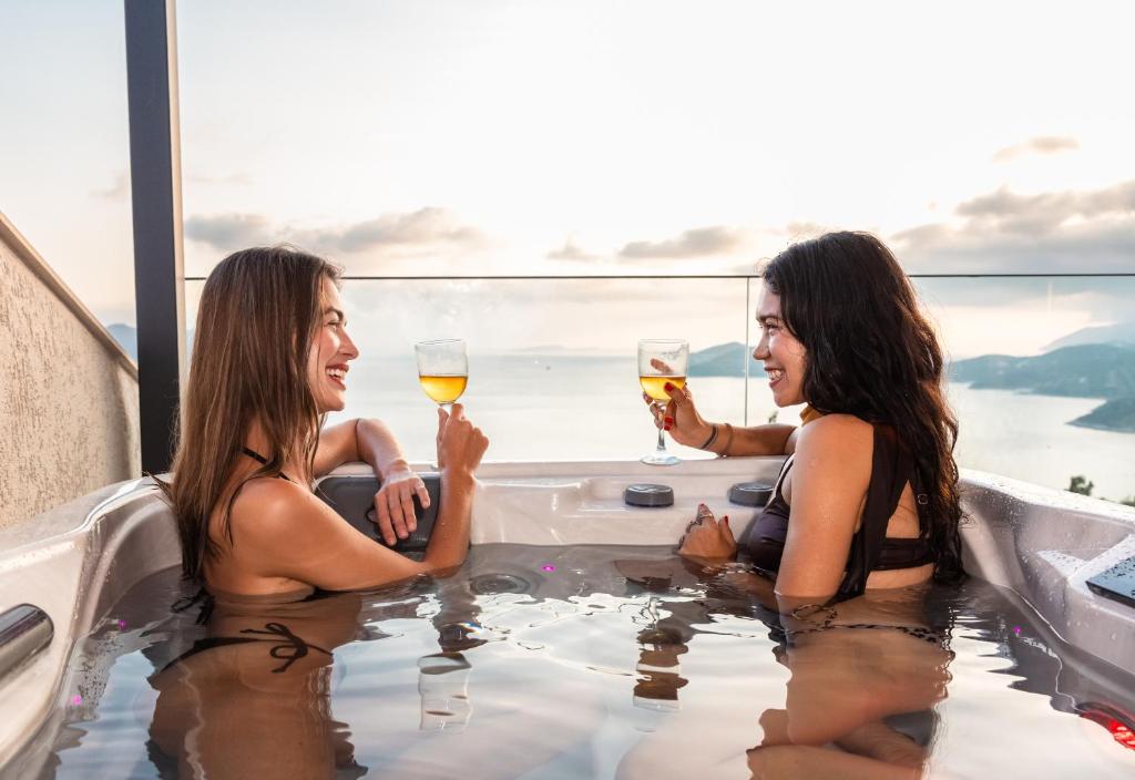 two women drinking champagne in a bathtub at Serenity Pearl in Kaş