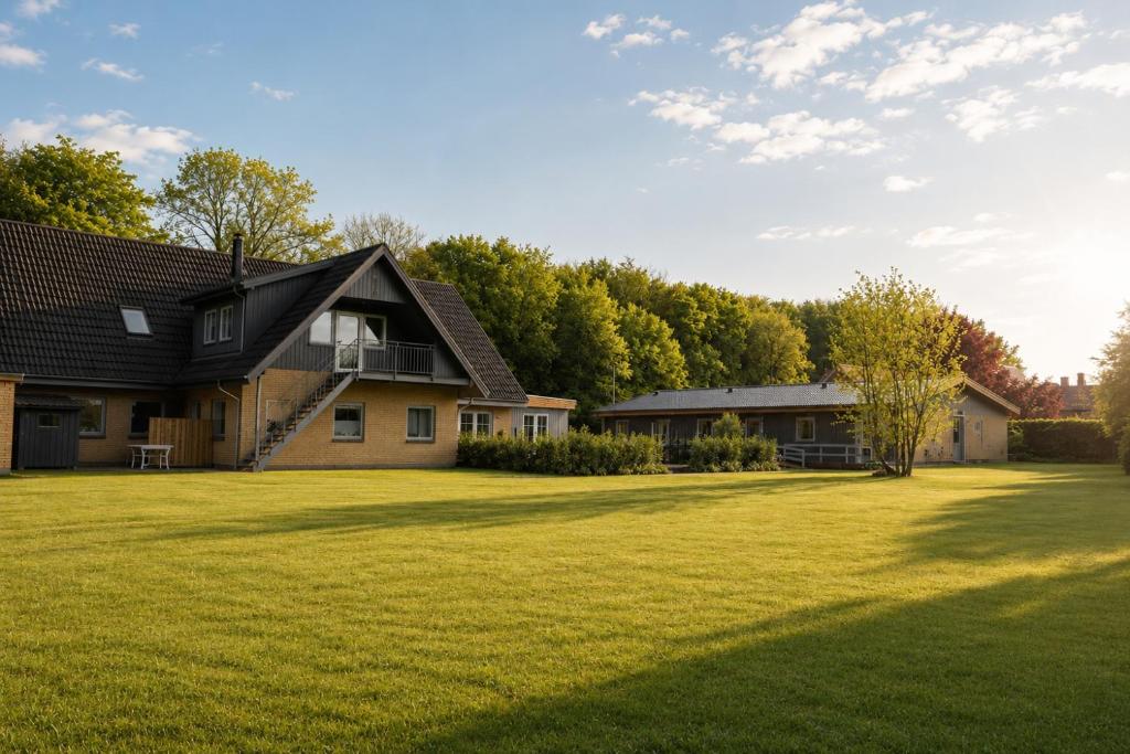 a house in a yard with a large grass field at KragenæsHus in Torrig