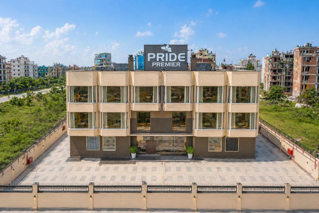 a building with a sign on top of it at Pride Premier Greater Noida in Noida