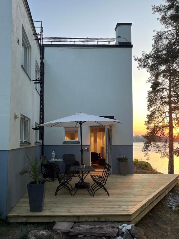 a patio with a table and an umbrella at Badklippan in Stockholm